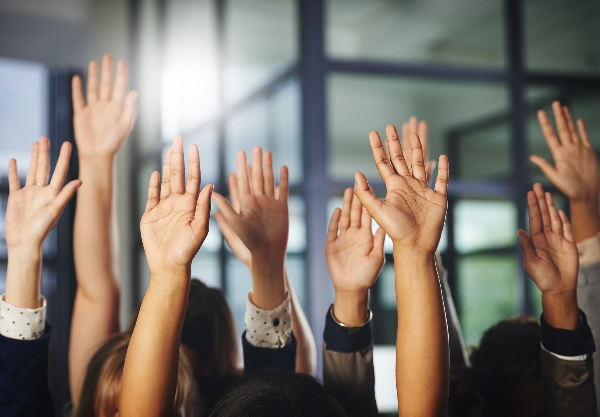 Raised hands of people wanting to ask questions about social media